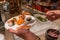 Human picking sashimi into his plate in luxury buffet restaurant