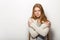 Human pose expressions and emotions. Portrait of young adorable redhead woman with gorgeous extra long hair in cozy sweatshirt loo