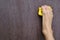 human right barefoot like a hand holds on yellow climbing hold on artificial climbing wall, concept of fun sport, copy space