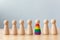 Human rights of LGBT campaign. Wooden dolls with rainbow colours are different stand out from crowd