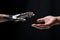 Human and robot hands reaching out to each other on black background, Technology meets humanity background, a modern human hand