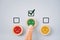 Human`s finger choose smiling green face on small circle wood for feedback, rating, ranking, customer review for service
