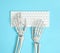 Human skeleton using computer keyboard on light blue background