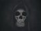 Human skull in hood. Halloween grunge background