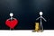 Human stick figure holding a red heart shape and another with gold coins. Money versus love, family or career, and health over eco