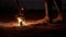 Human torches a torch from a burning poi lying on the ground