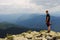 A human traveler enjoys the view of the mountains.Relaxing meditation on the top of a mountain.