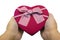 Human two hand holding gift present for lover heart shape. Beauty ribbon white and red color wrap box. surprise parcel for party.