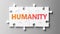 Humanity complex like a puzzle - pictured as word Humanity on a puzzle pieces to show that Humanity can be difficult and needs