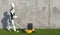 A humanoid robot mows grass with a lawn mower. Future concept with robotics and artificial intelligence. 3D rendering