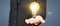 Humans hold light bulbs in hand innovative technology