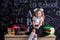 Humbled schoolgirl sitting on the desk with books, school supplies