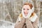 Humeral portrait of red-haired girl in earmuffs,