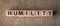 HUMILITY word made with building wooden blocks on table