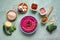 Hummus with beets on the table and ingredients for traditional hummus.