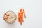 Hummus with carrot sticks. Top view of humus with carrot isolated on white background.