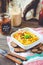 Hummus, chickpea dip, with rosemary, smoked paprika and olive oil on a wooden background. Rustic. Healthy lifestyle and balanced