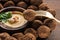 Hummus and falafel served on wooden table with fork.