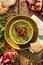 Hummus. Herbal hummus with the addition of pomegranate seeds, parsley, olive oil and aromatic spices in a ceramic pot on a wooden