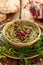 Hummus. Herbal hummus with the addition of pomegranate seeds, parsley, olive oil and aromatic spices in a ceramic pot on a wooden