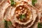 Hummus with paprika and parsley macro horizontal top view