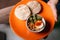 Hummus and pita on an orange plate