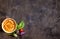 Hummus on a plate with cherry tomatoes and herbs on a dark woode