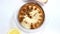 Hummus in a plate on a light background with white bread, garlic and lemon. A traditional snack from the Middle East.