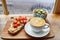 Hummus and tomato sandwich, salad and fresh hot cappuccino coffee