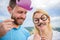 Humor and laugh concept. Couple posing with party props sky background. Photo booth props. Man with beard and woman