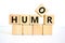 Humor symbol. The concept word `humor` on wooden cubes. Beautiful white table, white background, copy space. Business,