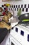 Humorous photography , dogs acting like humans . Boston Terrier in a black apron cooking on a gas stove