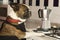 Humorous photography , dogs acting like humans . Boston Terrier in a black apron prepares coffee in a coffee maker