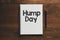 HUMP DAY text written in an office notebook on a wooden table