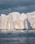 Humpback whales merrily feeding in the rich glacial waters among giant icebergs at the mouth of the Icefjord, Ilulissat