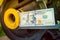 Hundred dollar bill close-up on an industrial background. Money on a belt driven tractor engine pulley. Production costs and the