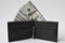 Hundred-dollar bills in black wallet