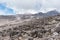 Hundreds of igneous volcanic rocks scattered across the alpine desert zone landscape of Mount Kilimanjaro, Tanzania