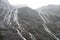 Hundreds of waterfalls flowing from the mountains during the rainstorm in Fiordland National Park, New Zealand