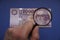 Hungarian 10000 forint banknote, with a portrait of Saint IstvÃ¡n King. Examine through the magnifying glass.