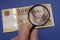 Hungarian 5000 forint banknote, on it Portrait of IstvÃ¡n Szechenyi. Examine through the magnifying glass.