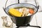 Hungarian chicken soup in a black kettle