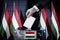 Hungary flags, hand dropping ballot card into a box - voting, election concept