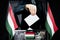 Hungary flags, hand dropping voting card - election concept