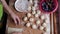 In a Hungaryan kitchen the senior women make homemade pastrys, plum dumplings