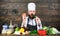 Hunger and appetite. Healthy vegetarian recipe. Man bearded hipster hat and apron cooking healthy food. Vegetarian