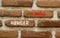Hunger crisis symbol. Concept words Hunger crisis on beautiful brown brick wall on a beautiful brown brick wall background.