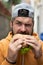 Hunger Man eat burger outdoor. Man eat tasty Hamburger on street. Burger on lunch. Cheeseburger or hamburger. Man eating