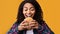 Hungry African American Lady Eating Burger At Studio