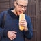 Hungry bearded customer eating delicious fast food: hotdog. Outs